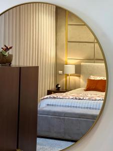 a bedroom with a bed and a mirror at Royal Fraga do Douro in Vila Real