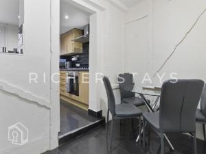 ein Esszimmer mit weißen Wänden sowie einem Tisch und Stühlen in der Unterkunft Rustic 3BR house in Tilbury, Garden and Parking in Tilbury