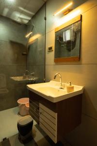 a bathroom with a sink and a toilet at Green Home Stay - 10 Mins Walk to Kanyakumari Main Beach in Kanyakumari +25 photos