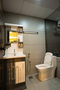 a bathroom with a toilet and a sink at Green Home Stay - 10 Mins Walk to Kanyakumari Main Beach in Kanyakumari