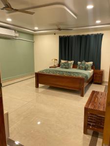 a bedroom with a bed in a room with a window at Green Home Stay - 10 Mins Walk to Kanyakumari Main Beach in Kanyakumari