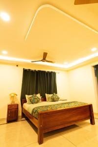 a bedroom with a bed and a ceiling fan at Green Home Stay - 10 Mins Walk to Kanyakumari Main Beach in Kanyakumari