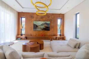 a living room with a couch and a chandelier at Villa Jamila Marrakech in Segraga