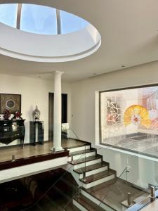 a living room with a glass staircase and a piano at Royal Fraga do Douro in Vila Real