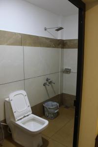 a bathroom with a toilet and a shower at Skyline Inn in Anachal +10 photos