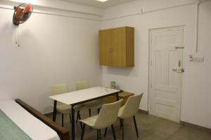 a dining room with a table and chairs and a door at Skyline Inn in Anachal