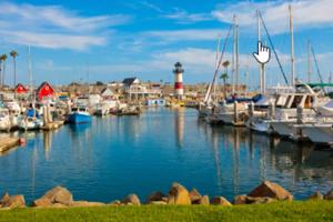 a marina with boats in the water and a lighthouse at Luxury Cozy Studio with Firepit in Vista