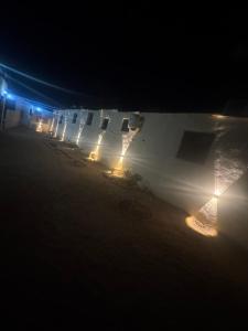 una fila de edificios con luces en la oscuridad en Jory Studios, en Dahab