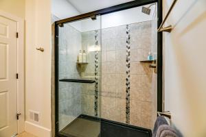 a shower with a glass door in a bathroom at Luxurious Litfin Loft - Walk to Main St Akron in Akron +17 photos