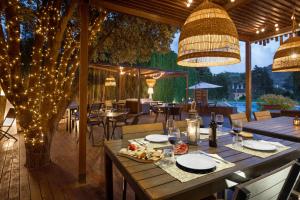 a patio with a table and chairs and lights at Hotel & Spa Golden Barcelona in Vallromanas