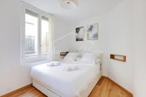 a white bedroom with a white bed and a window at New, Elegant & Cozy, 2 Guests in Bagneux