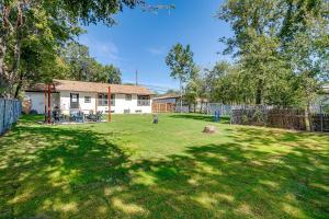a yard with a fence and a house at NEW Howdy House, Walk to TSU, Gameroom & Yard in Stephenville