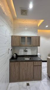 a kitchen with a sink and a counter top at شقق يودج in Tabuk +4 photos