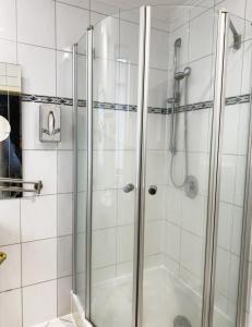 a bathroom with a shower and a toilet at HOTEL S Norderstedt in Norderstedt