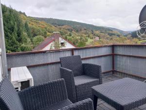 a balcony with two chairs and a table with a view at Waldblick in Hirschhorn in Hirschhorn