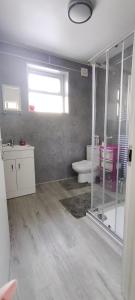 a bathroom with a shower and a toilet in it at Quality Rooms in Liverpool +44 photos
