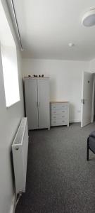 an empty office room with white cabinets and a desk at Quality Rooms in Liverpool
