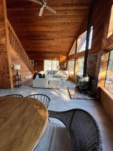 a large living room with a table and chairs at Little Bear Lodge in Springville