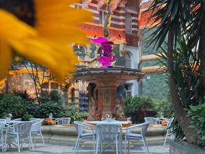 a fountain in a courtyard with tables and chairs at Taj 51 Buckingham Gate Suites and Residences in London