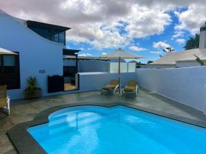 a swimming pool in the backyard of a house at Nazaret Villa with heated pool in Nazaret