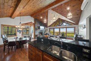a kitchen with two sinks and a dining room at Sit Stay Play in Beech Mountain