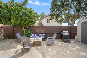 a patio with chairs and a couch and a table at Luxury Cozy Studio with Firepit in Vista