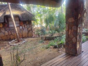 an outside view of a stone building with a porch at Clarky's Pride Lodge in Alldays