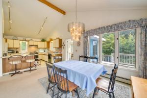 a dining room and kitchen with a table and chairs at Charming Retreat with Deck about 4 Mi From Casco Bay! in Orrs Island