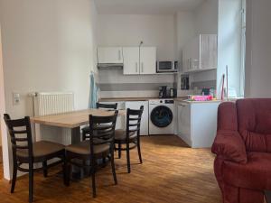 a kitchen with a wooden table and chairs and a kitchen with a table at Stay Zentral Dresden in Dresden