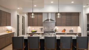 a kitchen with a large island with chairs in it at Princetown Grande in Steamboat Springs