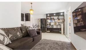 a living room with a brown couch in a room at Semi-detached villa sea views, huge terrace, close beach in Palm-mar