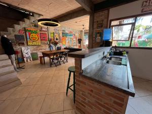 a kitchen with a sink and a counter in a restaurant at Tia Chica Camburi in Camburi