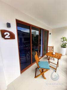 a room with a table and a chair at Makadal'Eau Boutique Resort in Siquijor