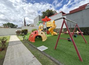 a playground with a slide and a swing at Luxury San Jose aptartment Central&Chic in San José