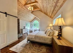 a bedroom with a bed and a wooden ceiling at The Pink House in Banner Elk