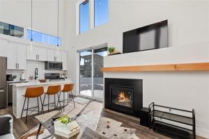 a kitchen and living room with a fireplace at Quarry A28 in Whitefish