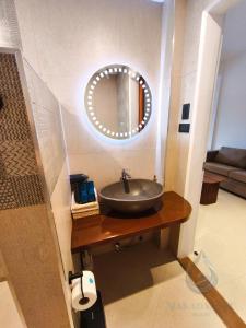 a bathroom with a sink and a mirror at Makadal'Eau Boutique Resort in Siquijor