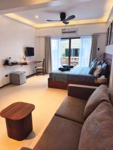 a living room with a bed and a couch at Makadal'Eau Boutique Resort in Siquijor