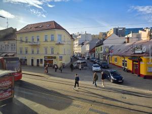 a group of people walking down a city street at KAVE Obchodná Apartments in Bratislava
