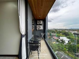 a balcony with a table and a view of a city at Condo sea view rawai beach by phuket sweet home in Rawai Beach