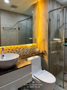 a bathroom with a toilet and a sink and a shower at Condo sea view rawai beach by phuket sweet home in Rawai Beach