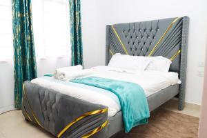 two beds in a bedroom with a metal headboard at The Royals in Tatu City +9 photos