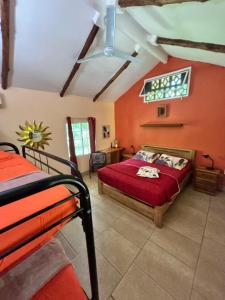 a bedroom with two beds and a red wall at Cabanas Los Colibris Hotel Ecolodge in San Carlos +83 photos