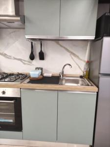 a kitchen with white cabinets and a sink at Verona Dreams in Verona