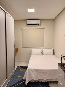 a bedroom with a bed and a air conditioner at Tropical House Santarém in Santarém