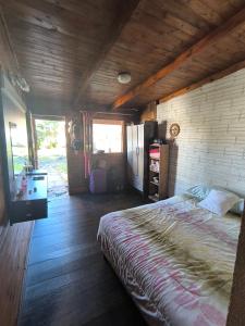 a bedroom with a bed and a wooden ceiling at Guavirá cabañas and rooms in Puerto Iguazú