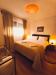 a bedroom with a large bed and a window at DiViNI apartment in Zadar