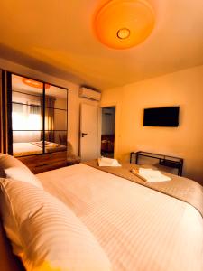 a hotel room with two beds and a mirror at DiViNI apartment in Zadar