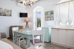 a kitchen and dining room with a blue table and chairs at Geronti Moscha Apartment in Apollonia