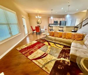 a living room with a couch and a kitchen at Your Lawrenceville home in the heart of it all in Lawrenceville +10 photos